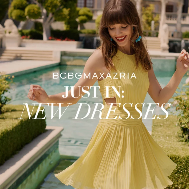 Woman in a yellow pleated dress poses joyfully outdoors by a pool with greenery. Text reads "BCBGMAXAZRIA - Just In: New Dresses.