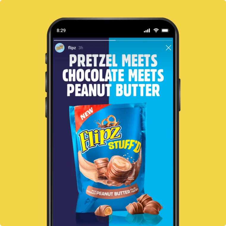 Phone screen displaying an advertisement for Flipz Stuff'd with a bag featuring chocolate-covered pretzels filled with peanut butter against a blue background. Text reads: "Pretzel meets chocolate meets peanut butter.