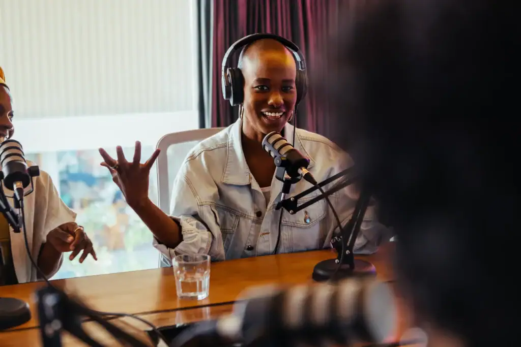A person wearing headphones and speaking with a microphone.